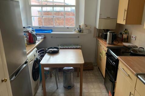 Compact, well-equipped kitchen with natural win...