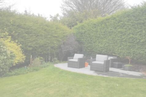 A beautifully manicured garden with comfortable...