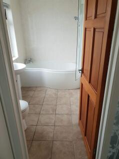 A bright and tidy bathroom featuring a comforta...