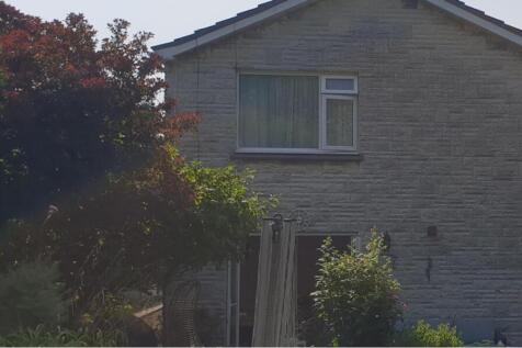 A charming exterior view of the property with w...