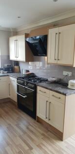 A modern kitchen with ample storage and a styli...