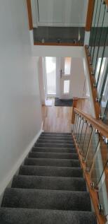 A bright and tidy hallway featuring modern fini...