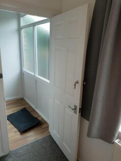 A bright and tidy hallway with natural light fi...