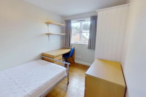 Bright, simply furnished single bedroom with a ...