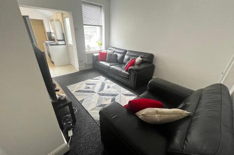 Bright, simply styled living room with two blac...