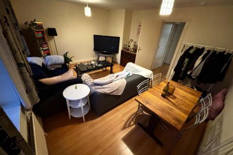 Warm, furnished living room with a comfy sofa a...