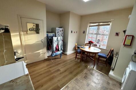 Bright kitchen/dining area with a round wooden ...