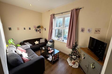 Bright, cosy living room with two comfortable s...