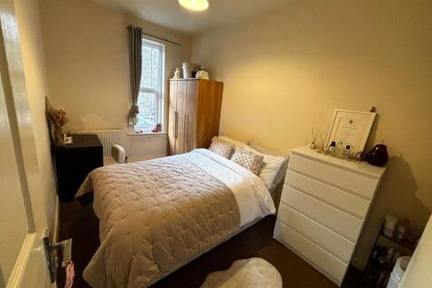 Bright, neatly presented bedroom with a comfort...