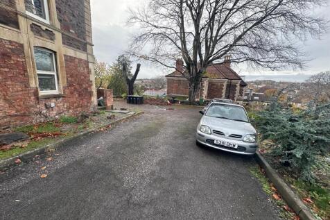 Gravel driveway and parking area beside a perio...