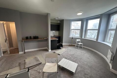 Spacious, bright living area with large bay win...