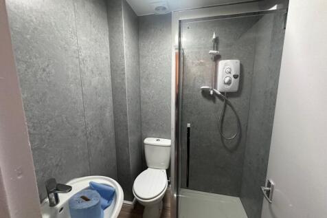 Modern compact bathroom with a walk-in shower, ...