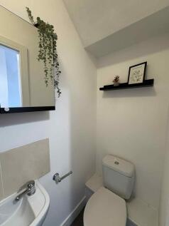 Compact, neatly presented WC with a modern clos...