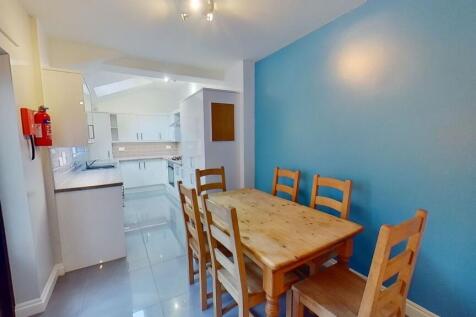 Bright open-plan kitchen and dining area with a...
