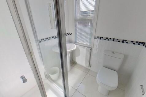 Bright, modern bathroom with a walk-in shower, ...