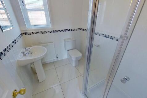 Bright, modern bathroom with a tiled floor, ped...