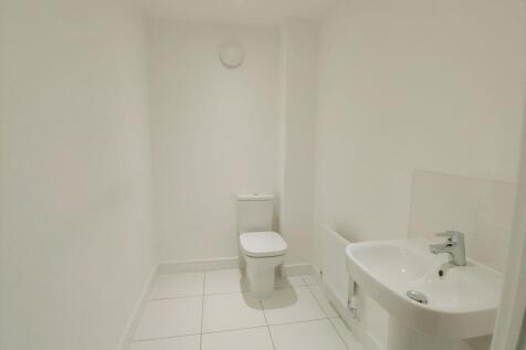 Bright, modern white bathroom with a sleek pede...