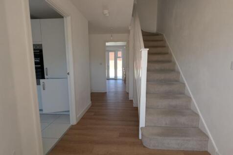 Bright, modern entrance hallway with wood-effec...