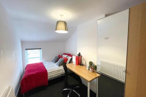 Bright, neatly presented bedroom with a comfort...