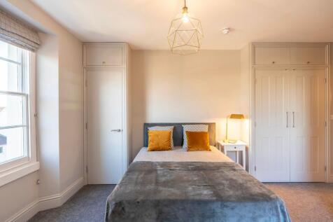Bright, neatly presented bedroom with a comfort...