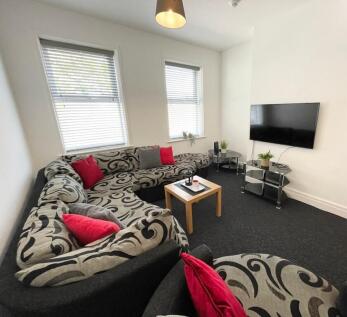 Bright, modern living room with a large pattern...