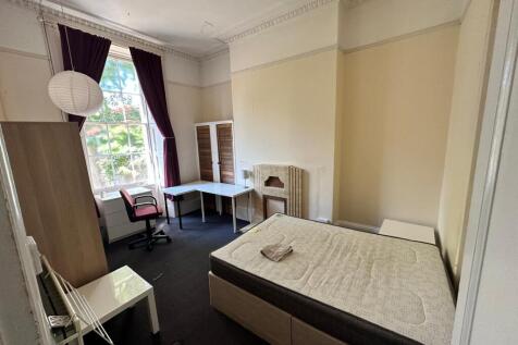 Bright, well-proportioned bedroom with high cei...