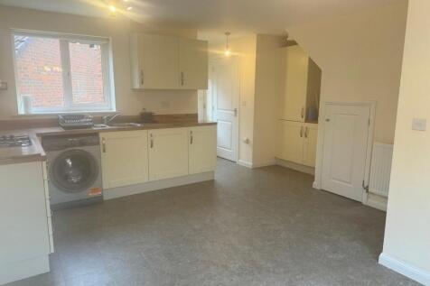 Bright modern kitchen with light-coloured cabin...