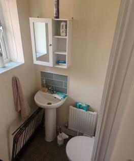 Compact, well-kept bathroom with a pedestal sin...