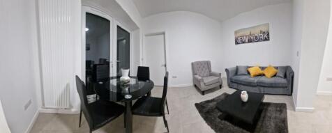 Bright, modern living room with a compact dinin...