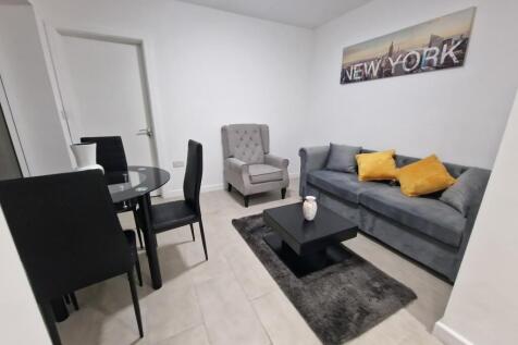 Bright, modern living room with a comfortable g...