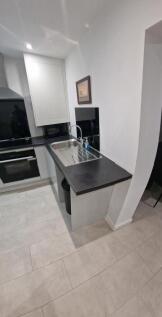 Modern galley-style kitchen with a stainless st...