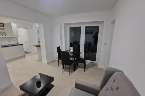 Bright, modern open-plan living area with a com...