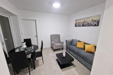 Bright, modern living room with a comfortable g...