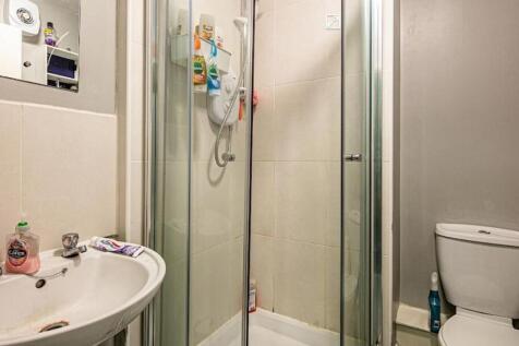 Compact bathroom with a corner shower cubicle, ...