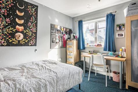 Bright, neatly kept bedroom with a double bed, ...