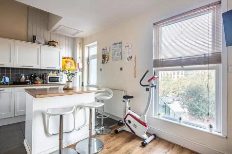 Bright and modern kitchen featuring a breakfast...