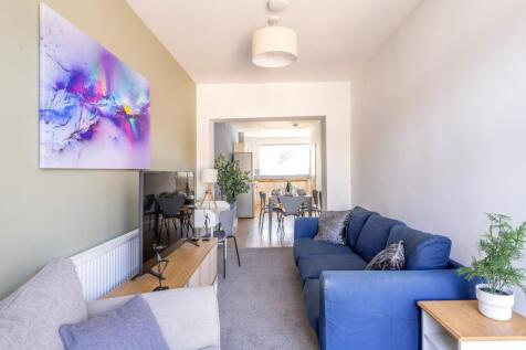 Bright, modern open-plan living area with a com...