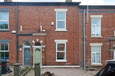 Red-brick terraced house with arched twin doorw...