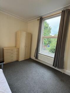 Bright furnished bedroom with large sash window...