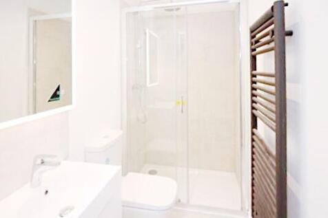 Bright, modern bathroom with a walk-in shower, ...