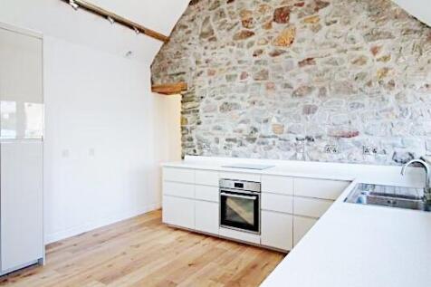 Bright, modern kitchen with sleek white cabinet...