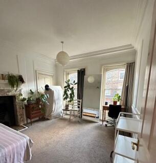 Bright, elegant bedroom with high ceilings, lar...