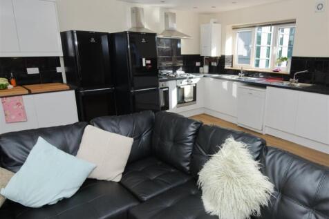 Bright open-plan living area with a modern whit...