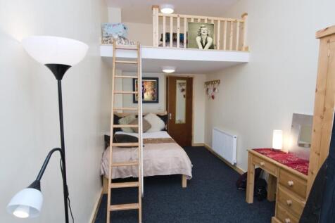 Bright, well-arranged bedroom with a comfy doub...