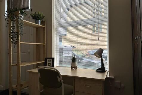 Bright ground-floor workspace with a large wind...