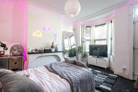 Bright, stylish bedroom with a comfortable doub...