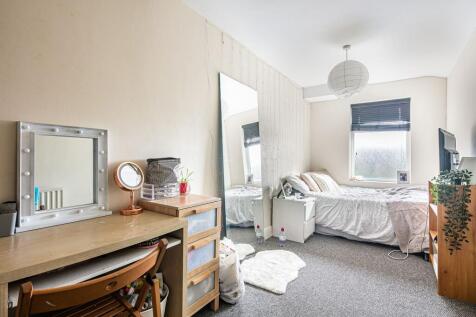 Bright, neatly styled bedroom with a cosy doubl...