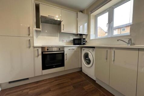 Bright modern kitchen with glossy fitted cabine...