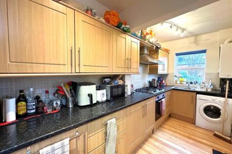 Bright, well-equipped galley kitchen with light...