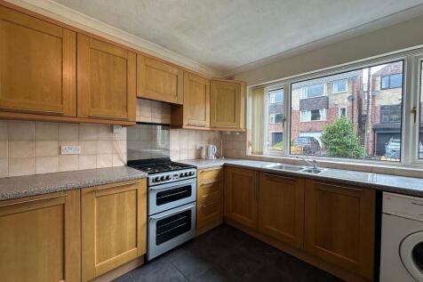 Well-presented kitchen with plentiful wooden ca...